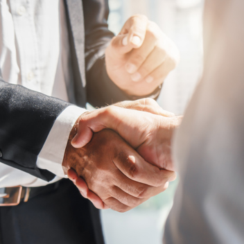 Handshake between businessmen zoomed in on their hands