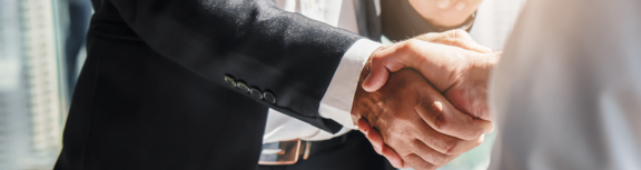 Handshake between businessmen zoomed in on their hands